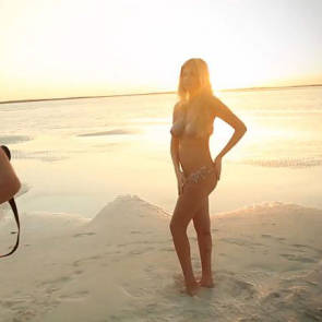 Kate poses with body paint on the beach