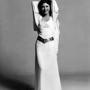 Carrie Fisher posing in a white dress