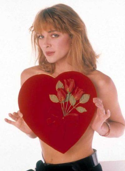 Kim Cattrall is topless with a heart on her breast