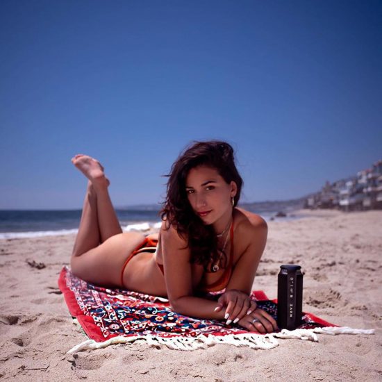 Lexi Pantera laying on the beach