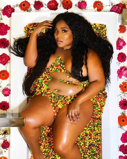 Lizzo in a bathtub full of candy