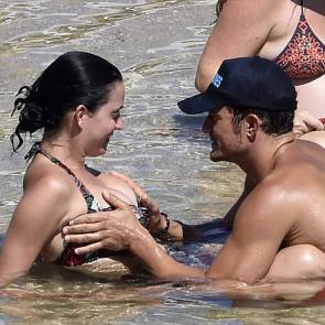 Orlando Bloom is touching Katy Perry's breasts