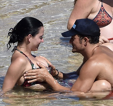 Orlando Bloom is touching Katy Perry's breasts