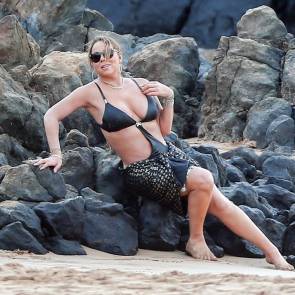 Mariah Carey in black bikini on the rocks