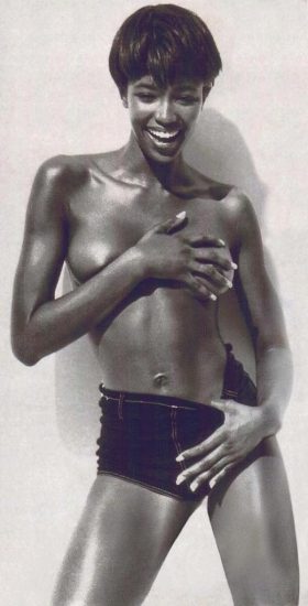 Naomi Campbell covering her breasts with her hands